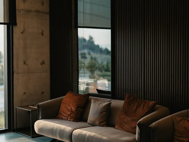 brown and white couch beside window